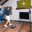 Two people playing a golf simulation game in a living room