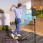 Golf simulator setup with a person, phone, and tripod indoors.